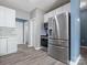 Bright kitchen featuring stainless steel appliances, white cabinets, and light grey backsplash and flooring at 1579 Matthews Dr, Rock Hill, SC 29732