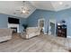 Comfortable living room with fireplace, TV, vaulted ceilings, wood flooring, and neutral-toned furniture at 1579 Matthews Dr, Rock Hill, SC 29732