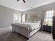 Elegant main bedroom with carpet, ensuite bathroom access, and large picture window at 1579 Matthews Dr, Rock Hill, SC 29732