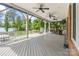 Enjoyable back deck offers multiple ceiling fans, a bar area, and outdoor seating with lake views at 17112 Green Dolphin Ln, Cornelius, NC 28031