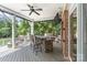 Covered back deck featuring a bar area with a sink, seating, and views of the outdoor fire pit at 17112 Green Dolphin Ln, Cornelius, NC 28031