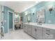 Elegant bathroom with dual vanities, makeup station, marble flooring, and modern fixtures at 17112 Green Dolphin Ln, Cornelius, NC 28031