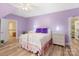 Comfortable bedroom featuring wood floors, purple walls, and a white iron bed frame at 17112 Green Dolphin Ln, Cornelius, NC 28031