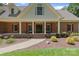 Inviting front porch with brick accents and a well-maintained walkway at 17112 Green Dolphin Ln, Cornelius, NC 28031