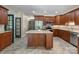 Elegant kitchen with granite counters, stainless appliances, and a central island with wooden cabinetry at 17112 Green Dolphin Ln, Cornelius, NC 28031