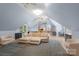 An open plan living room features a high ceiling, a plush sectional, a kitchen, and a dining space at 17112 Green Dolphin Ln, Cornelius, NC 28031