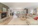 Cozy living room with a stone fireplace, hardwood floors, neutral walls, and an open view to the dining area at 17112 Green Dolphin Ln, Cornelius, NC 28031