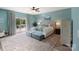 Spacious main bedroom with balcony access is complete with sitting area and plush carpeting at 17112 Green Dolphin Ln, Cornelius, NC 28031