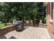 Secluded brick patio with a covered grill and garden shed, perfect for outdoor dining and entertaining at 17112 Green Dolphin Ln, Cornelius, NC 28031