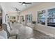 Bright sun room overlooking lake with floor to ceiling windows and tile floor at 17112 Green Dolphin Ln, Cornelius, NC 28031
