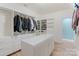 Spacious walk-in closet with a center island and custom shelving at 17112 Green Dolphin Ln, Cornelius, NC 28031