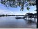 Beautiful waterfront home featuring a private boat dock, with clear blue waters and open sky at 17112 Green Dolphin Ln, Cornelius, NC 28031