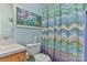 Bathroom featuring toilet, sink and vanity with a patterned shower curtain at 174 Stewart Acres Dr, Statesville, NC 28677