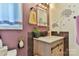 Stylish bathroom featuring a modern vanity, decorative mirror, and accent wall at 174 Stewart Acres Dr, Statesville, NC 28677