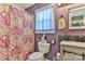 Cozy bathroom featuring paisley shower curtain, modern vanity, and decorative walls at 174 Stewart Acres Dr, Statesville, NC 28677