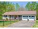 Charming home featuring a cozy front porch, well-maintained lawn, and an attached two car garage at 174 Stewart Acres Dr, Statesville, NC 28677