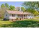 Well-kept home with a welcoming front porch, verdant lawn, and easy driveway access at 174 Stewart Acres Dr, Statesville, NC 28677