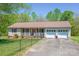 Charming home with a fenced yard, well-manicured lawn, and a two-car garage at 174 Stewart Acres Dr, Statesville, NC 28677