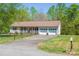 Ranch-style home with a well-maintained front yard, two-car garage and charming front porch at 174 Stewart Acres Dr, Statesville, NC 28677
