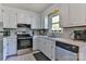 Functional kitchen with white cabinetry, stainless steel appliances, and modern countertops at 174 Stewart Acres Dr, Statesville, NC 28677