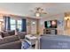 Relaxing living room featuring comfortable seating, a ceiling fan, and neutral wall colors at 174 Stewart Acres Dr, Statesville, NC 28677