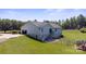 Home with an above-ground pool, deck, partially fenced yard, and detached garage at 260 Treebark Rd, Statesville, NC 28625