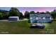 Dusk view of home with backyard, above-ground pool, deck, and detached garage at 260 Treebark Rd, Statesville, NC 28625