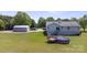 Home with an above-ground pool, deck, detached garage, and spacious backyard at 260 Treebark Rd, Statesville, NC 28625