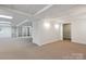 Spacious basement with carpet floors, shelving, and access to daylight at 260 Treebark Rd, Statesville, NC 28625