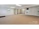 Finished basement with carpet floors, shelving, and outdoor access at 260 Treebark Rd, Statesville, NC 28625