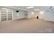 Large basement area with built-in shelves, neutral carpet, and lighting at 260 Treebark Rd, Statesville, NC 28625