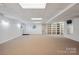 Basement with carpet floors, large storage shelves, and a window at 260 Treebark Rd, Statesville, NC 28625