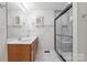 Modern bathroom with a double vanity, updated fixtures, and frameless glass enclosed shower at 260 Treebark Rd, Statesville, NC 28625