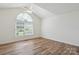 Bright bedroom with laminate wood flooring, ceiling fan, and large window at 260 Treebark Rd, Statesville, NC 28625
