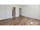 Bedroom with laminate floors, white walls, and three doors at 260 Treebark Rd, Statesville, NC 28625