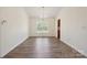 A bright dining room boasts wood-look flooring, chandelier and abundant natural light at 260 Treebark Rd, Statesville, NC 28625