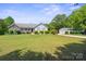 Charming single-story home with a lush lawn, complemented by a detached two-car garage and a tree-lined landscape at 260 Treebark Rd, Statesville, NC 28625