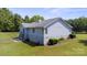 Home with a partially fenced yard, and stairs leading to the backyard at 260 Treebark Rd, Statesville, NC 28625