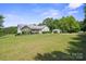 Charming single-story home with a lush lawn, complemented by a detached two-car garage and mature landscaping at 260 Treebark Rd, Statesville, NC 28625
