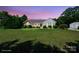 Charming single-story home with a lush lawn, complemented by a detached two-car garage and mature landscaping at 260 Treebark Rd, Statesville, NC 28625