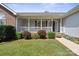 Inviting covered front porch features white railings, red shutters, and meticulously maintained landscaping at 260 Treebark Rd, Statesville, NC 28625