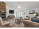 Virtually staged living room features an inviting seating area, a stone fireplace, and ample natural light at 260 Treebark Rd, Statesville, NC 28625