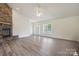 Bright and spacious living room with stylish wood flooring and a striking stone fireplace at 260 Treebark Rd, Statesville, NC 28625