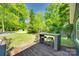 Back deck with outdoor table set surrounded by lush greenery at 309 N Congress N St, York, SC 29745