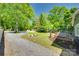 Large yard has a gravel area, a fire pit, deck, and flourishing rose bushes at 309 N Congress N St, York, SC 29745