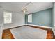 Bright bedroom with wood floors, ceiling fan, two windows, with one wallpapered accent wall at 309 N Congress N St, York, SC 29745