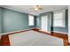 Bright bedroom features fresh paint, ceiling fan, hardwood floors, and natural light from large windows at 309 N Congress N St, York, SC 29745