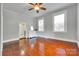 Bedroom with hardwood floors, ceiling fan, and bright windows overlooking the yard at 309 N Congress N St, York, SC 29745