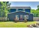 Home's exterior features a red door, lush landscaping, and a spacious yard at 309 N Congress N St, York, SC 29745