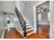 Classic staircase design with dark wood handrail and open floorplan concept at 309 N Congress N St, York, SC 29745